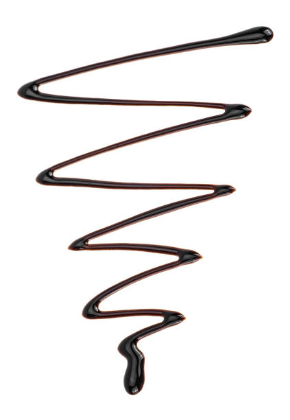 istock Abstract pattern made of chocolate isolated on white background. Sweet chocolate sauce. Chocolate syrup. 1279020580