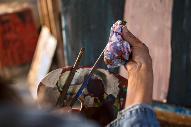 istock Woman painter cleaning brush close up 1279022920
