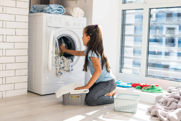 istock Little girl doing laundry. Housework concept. 1279023203