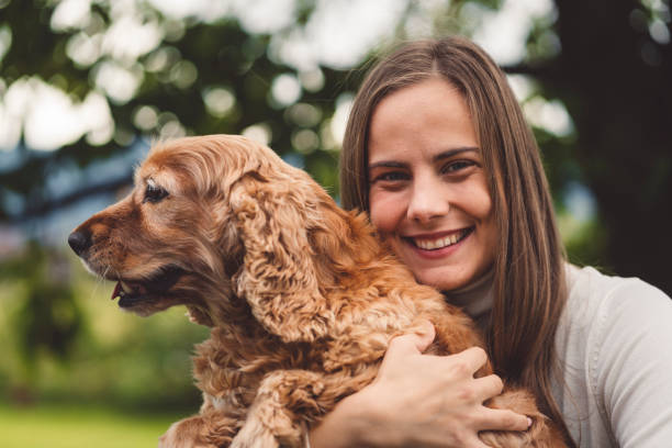 istock Smiling caucasian woman hugging her dog 1279024489