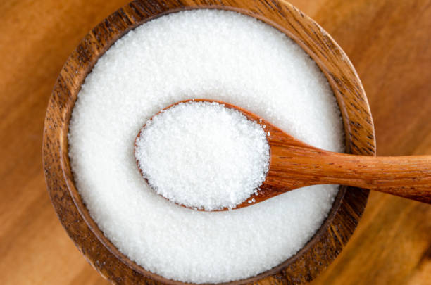 White Granulated Sugar In Wooden Bowl