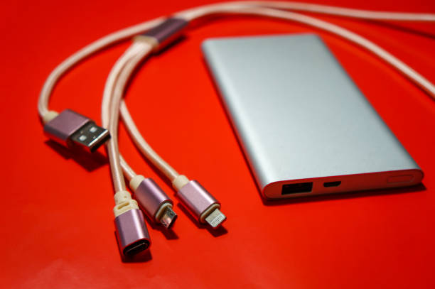 istock Power Bank external silver-colored battery with USB cable 1279029161