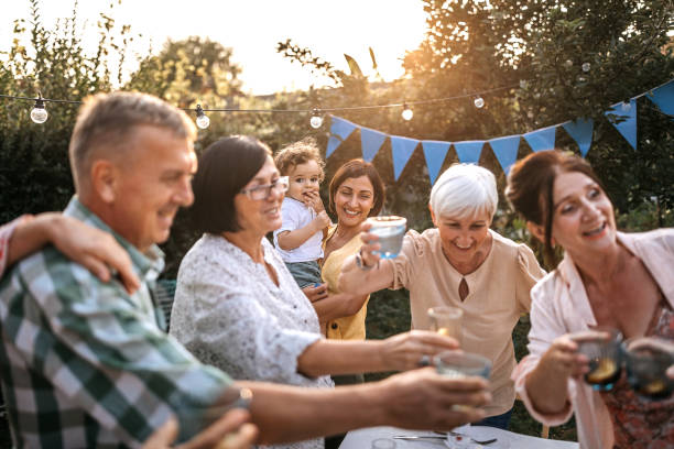 istock Happy friends celebrating with drinks at backyard 1279032237