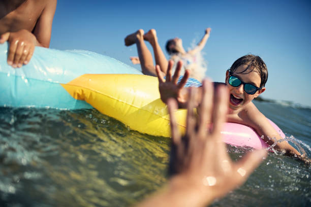 istock Kids playing in the sea on pool raft 1279034249