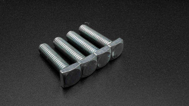 istock Silver colored square head screws on a black background 1279034658