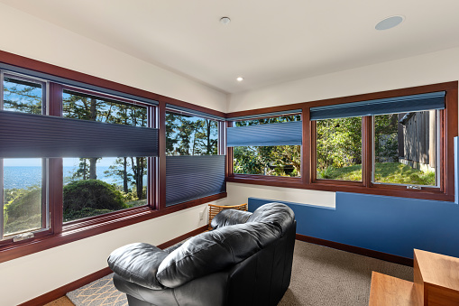Window coverings in home with view of the ocean