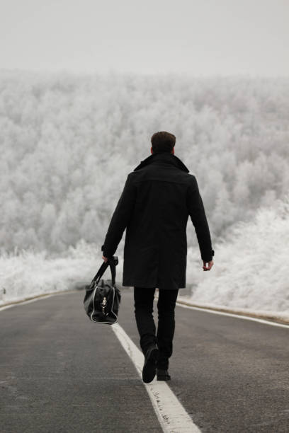 istock A handsome man looks forward to the first snow and a cold winter day 1279037276