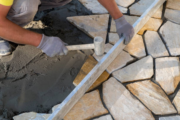 istock Hands of a worker laying new paving stones 1279037894