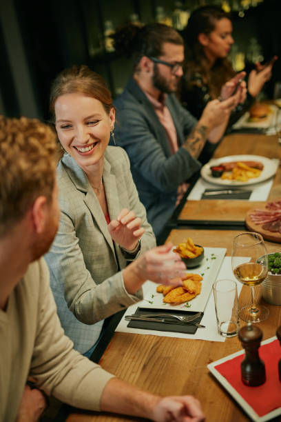 istock Attractive friends sitting in restaurant and having a good time. 1279040567