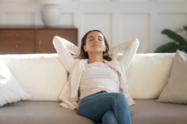 istock Peaceful young lady resting on comfy sofa enjoying calm moment 1279040599