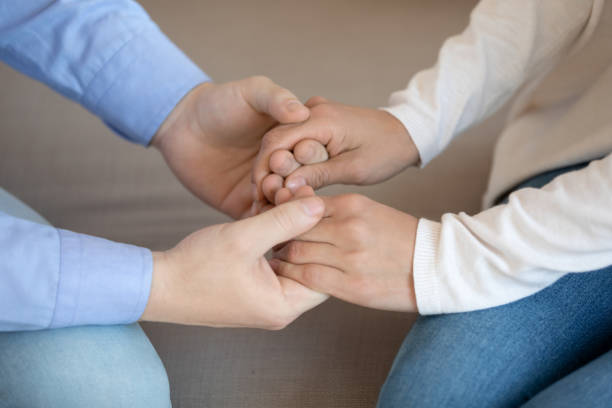 istock Young man holding female palms demonstrating support and care 1279040697