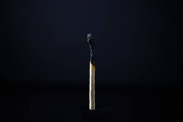 istock Single extinguished wooden match with black background. Frontal plane 1279042837