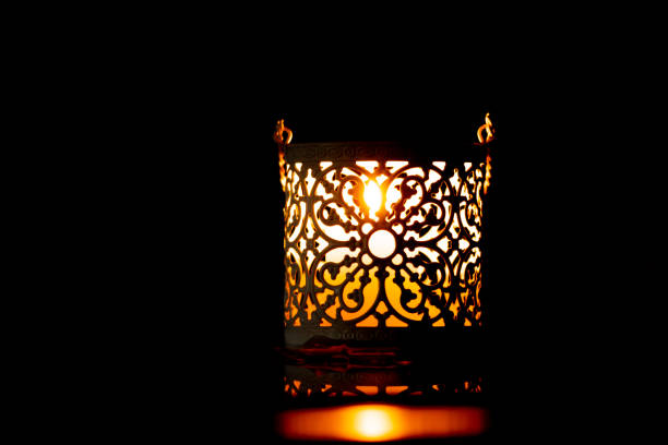 istock Christmas decorations: holey candle holders on dark table, closeup 1279043637