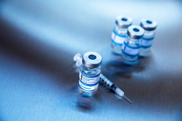 Coronavirus vaccine vials on a metal background