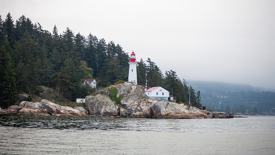 View of the Historic Lighthouse Point Park in West Vancouver off Point Atkinson, British Columbia, Canada. Taken from the water.