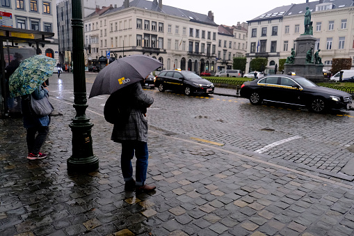 People protect themselves with umbrellas during heavy rainfall in Brussels, Belgium on  Sept. 28, 2020