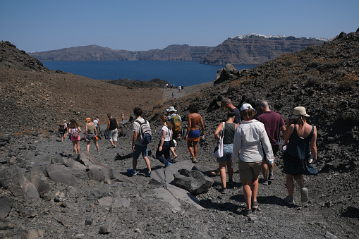 People walk in Nea Kameni Volcanic Park in Greece on August 16, 2020