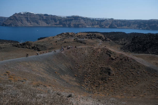 People walk in Nea Kameni Volcanic Park in Greece on August 16, 2020