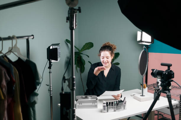 istock Female vlogger on set sending voice message on mobile phone 1279047878