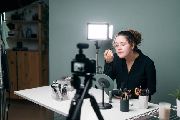 istock Young female vlogger applying makeup with paintbrush 1279047954