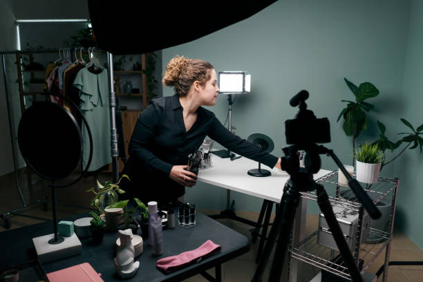 istock Female vlogger tidying up tables in studio 1279047959