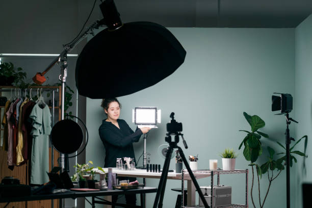 istock Female vlogger standing and arranging recording studio 1279047973