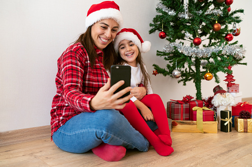 Mother and daughter making a video conference at christmas time