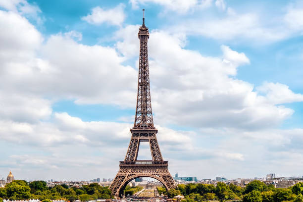 istock Eiffel Tower on background of blue cloudy sky. 1279050369