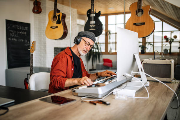 istock Senior musician playing digital piano at home 1279050475