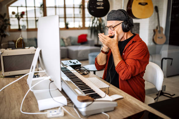 senior musician playing digital piano at home - wind instrument audio imagens e fotografias de stock