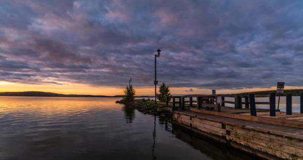 istock Sunrise over a Pier on a lake 1279051501