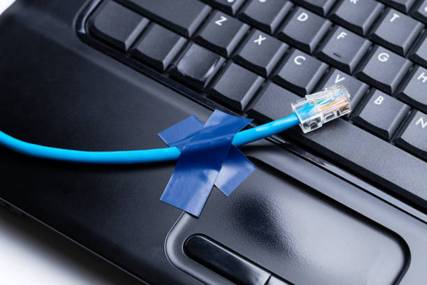 istock online and network connection problem conceptual. internet cable and black laptop on a white background 1279051548