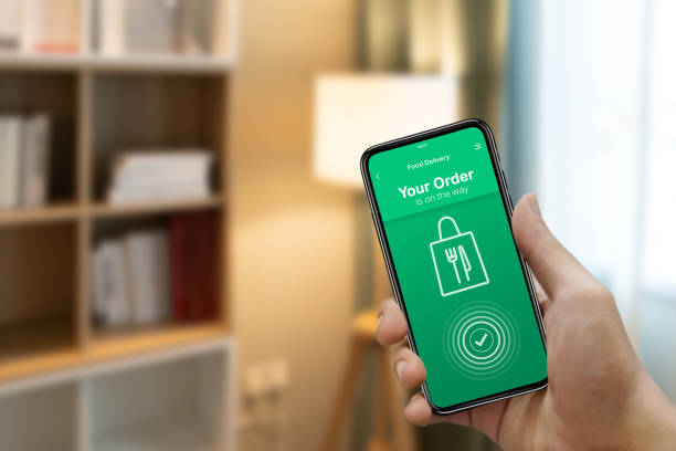 istock Ordering food online from home on mobile device app concept 1279054801