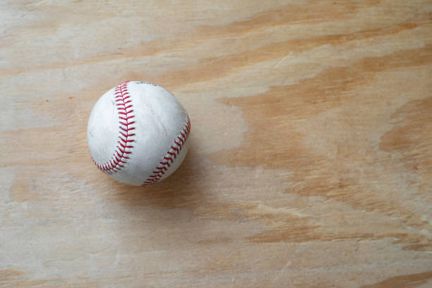 istock Baseball with a simple wood background 1279056832