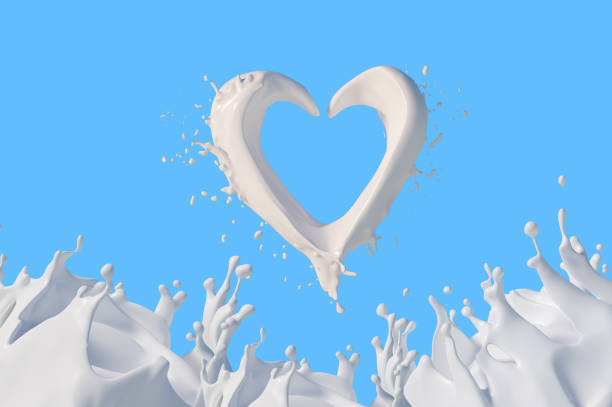 istock Milk heart and splashes, drops and blots on blue background 1279058250