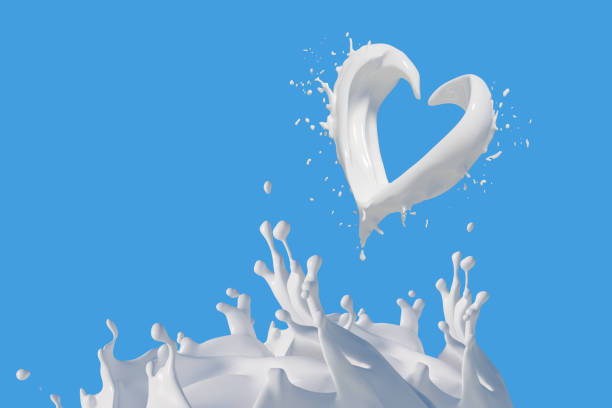 istock Milk heart and splashes, drops and blots on blue background 1279058251