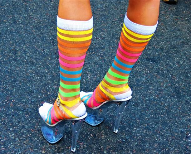 istock Beautiful legs  with  striped socks and heels shoes. 1279059116