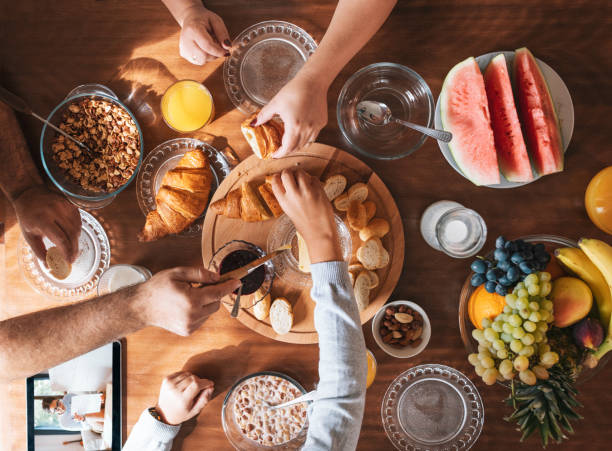 istock Breakfast table, family having healthy breakfast at home, directly from above. 1279059537