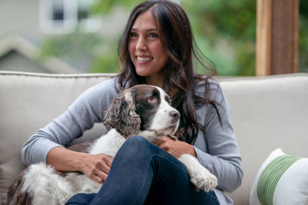 istock Mixed Race Woman Cuddling Pet Dog 1279059601