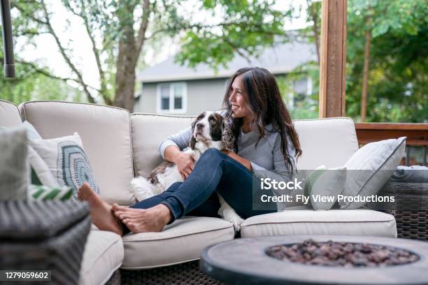 Beautiful Eurasian Woman Spending Time With Her Dog Outside Stock Photo - Download Image Now