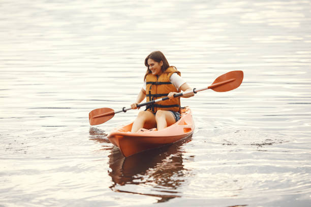 istock Woman paddling on a lake in a kayak 1279060021