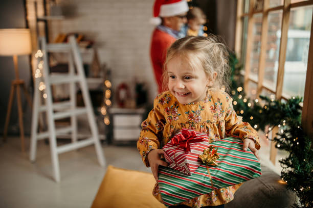 What we have inside the box Happy multi generation family celebrating Christmas in warmth of their home christmas excitement stock pictures, royalty-free photos & images