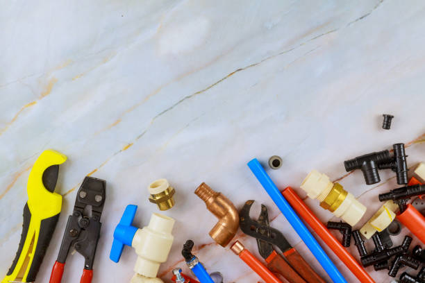 istock Plumbing tools, pipe fittings on a home improvement plumbing materials including copper pipe, elbow joint, wrench and spanner. 1279064317