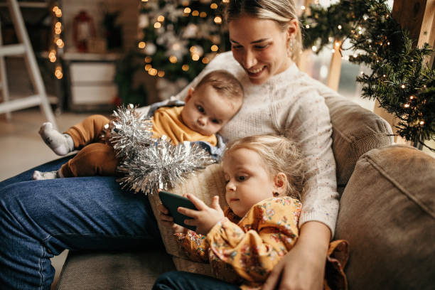 My world Mother waiting for Christmas at home with her childrens 2 5 months photos stock pictures, royalty-free photos & images