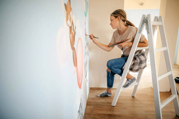 istock Artistic women decorating kids room 1279064395