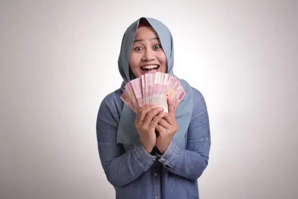 Photo of Indonesian Muslim Woman Holding Rupiah Money