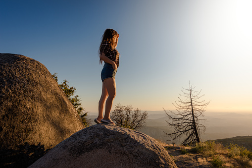 Idyllwild is nestled in the San Jacinto mountains. The small sleepy town is set among tall pines, sweet smelling cedars and rocks perfect for climbing. Charred trees are visible in the background, burnt from recent forest fires.