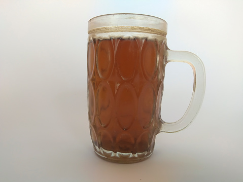 glass filled with tea water, isolated on white background