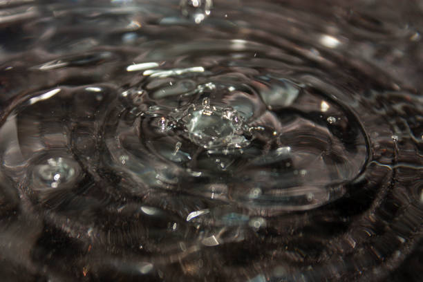 Raindrops on a lake as seen from underwater looking up
