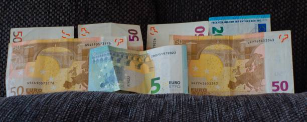 istock Symbolic Financial Bolster Banknotes on Couch 1279073676